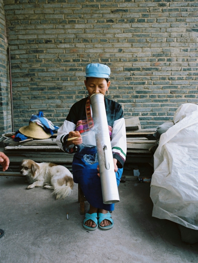 a woman smoking with a water pipe
